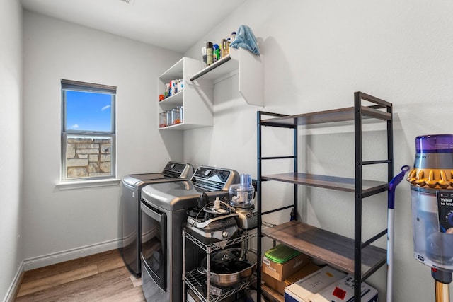 laundry room with washer and dryer, laundry area, light wood-style flooring, and baseboards