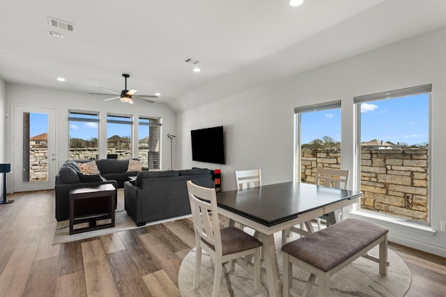 dining area featuring visible vents, plenty of natural light, and wood finished floors