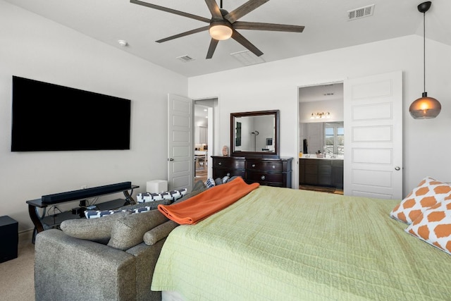 carpeted bedroom featuring visible vents, ensuite bath, a ceiling fan, and vaulted ceiling