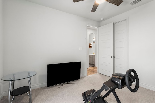 workout room with visible vents, carpet flooring, baseboards, and ceiling fan