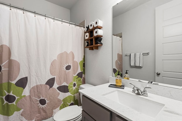 bathroom featuring vanity, toilet, and a shower with curtain