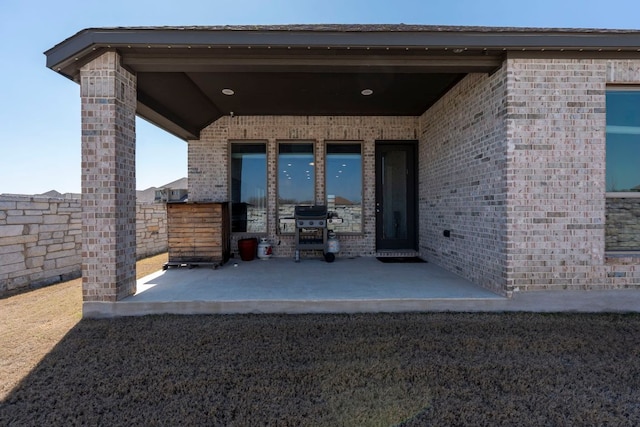 view of patio featuring area for grilling and fence