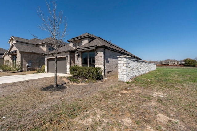 view of front of property with a garage, brick siding, and concrete driveway