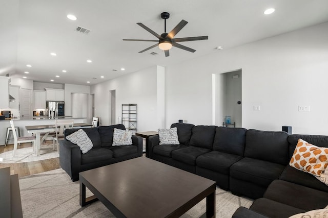 living area with recessed lighting, visible vents, a ceiling fan, and light wood finished floors