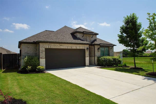 369 Cold River Run, Kyle, TX 78640 - french country inspired facade featuring brick siding, a garage, driveway, and a shingled roof