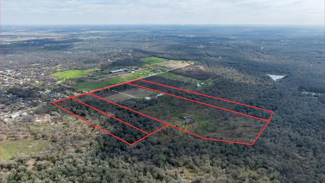 bird's eye view featuring a rural view and a wooded view