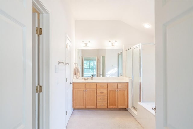 full bathroom with a bathtub, a shower stall, vanity, and vaulted ceiling