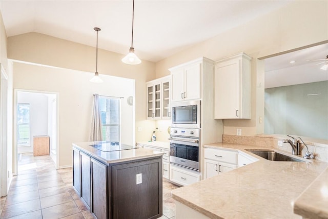 kitchen with stainless steel oven, glass insert cabinets, built in microwave, black electric cooktop, and a sink