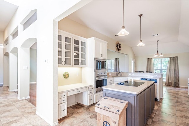 kitchen featuring glass insert cabinets, visible vents, light countertops, oven, and built in microwave