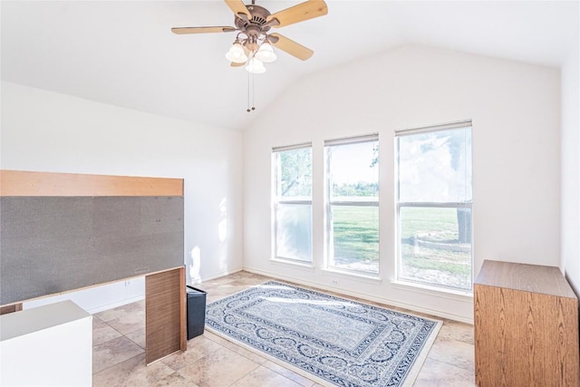 interior space featuring a ceiling fan and lofted ceiling