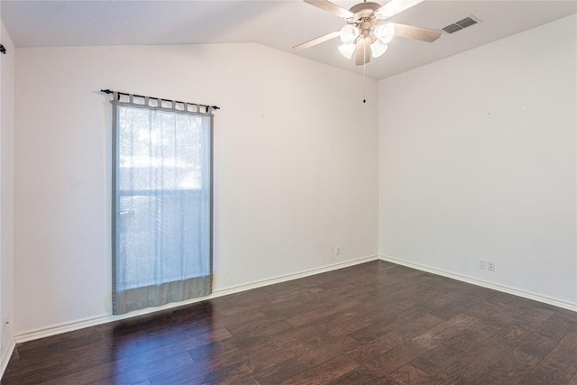 spare room featuring visible vents, baseboards, ceiling fan, vaulted ceiling, and wood finished floors