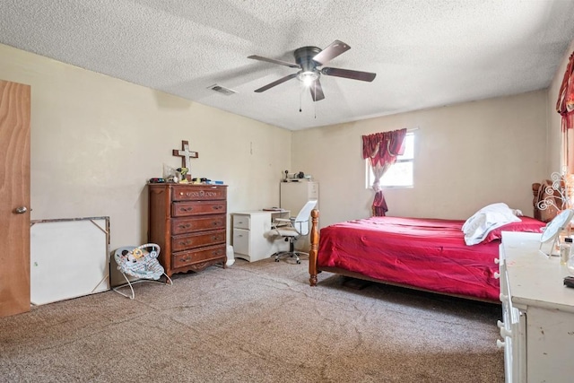 carpeted bedroom featuring visible vents, a textured ceiling, and ceiling fan