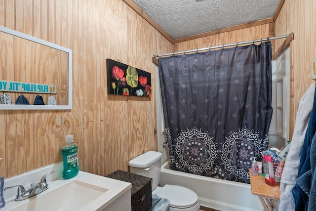 full bathroom with wood walls, shower / bath combo with shower curtain, toilet, a textured ceiling, and vanity