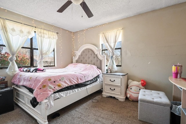 bedroom featuring a ceiling fan, carpet, and a textured ceiling