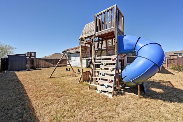 view of playground featuring an outbuilding, a storage unit, a fenced backyard, and a lawn