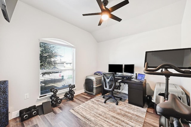 home office with baseboards, wood finished floors, a ceiling fan, and vaulted ceiling