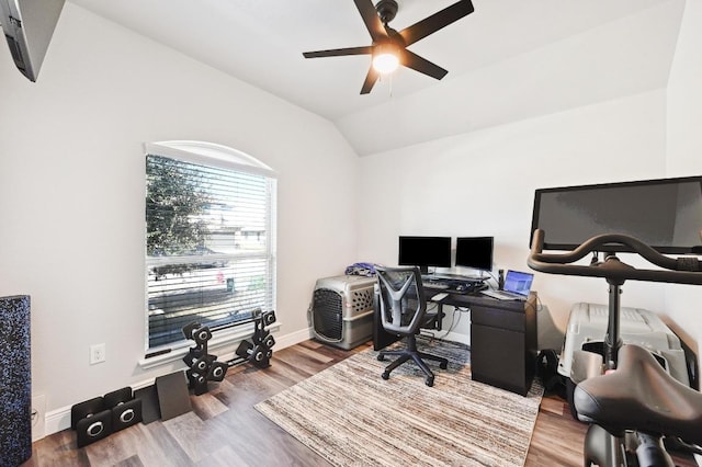 home office with lofted ceiling, a ceiling fan, wood finished floors, and baseboards