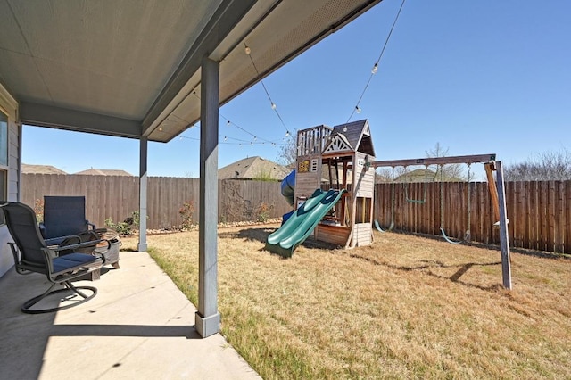 exterior space with a patio, a fenced backyard, and a lawn