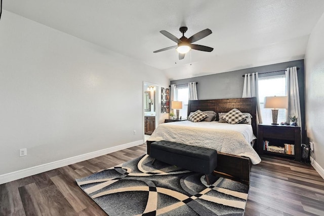 bedroom featuring dark wood-type flooring, baseboards, lofted ceiling, and ceiling fan