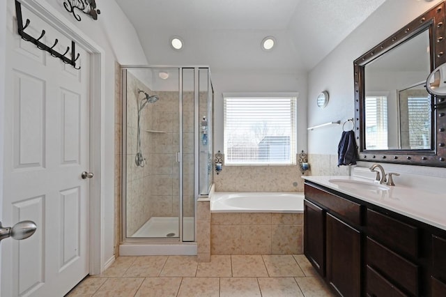 bathroom featuring tile patterned flooring, a garden tub, a stall shower, and a wealth of natural light