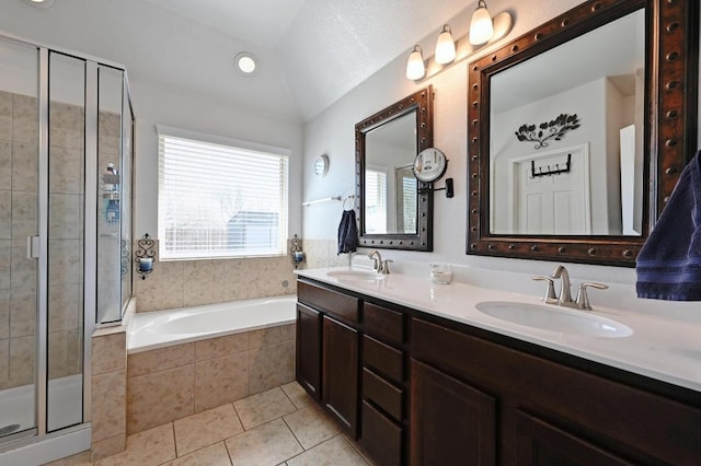 bathroom with a sink, a stall shower, a bath, and tile patterned floors