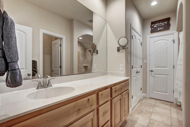 bathroom with vanity, tile patterned floors, and a shower