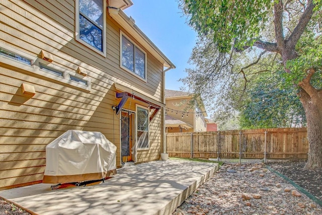 wooden deck with a patio area, grilling area, and fence