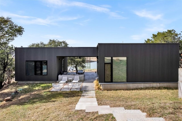 rear view of property featuring a patio area