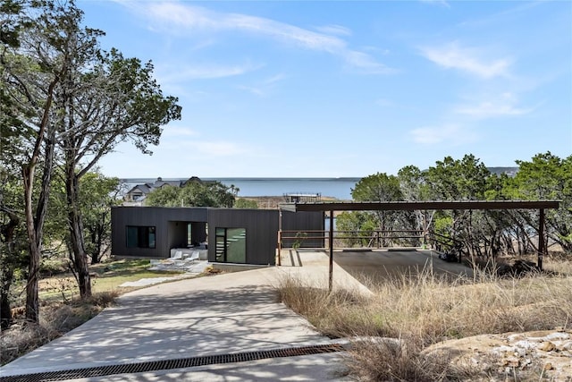 exterior space featuring driveway and a water view