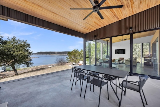 view of patio featuring outdoor dining area, ceiling fan, and a water view