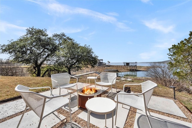 view of patio / terrace featuring a water view and an outdoor fire pit