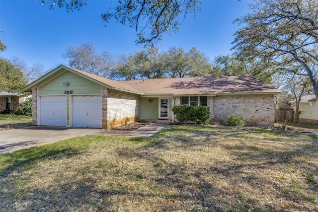 ranch-style house with driveway, a front yard, brick siding, and an attached garage