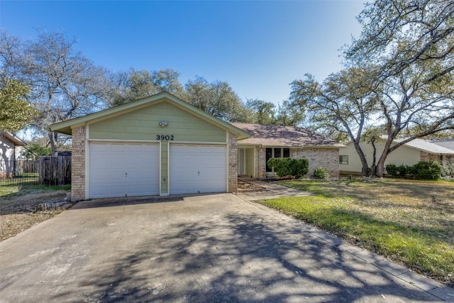 single story home with a front lawn, driveway, fence, a garage, and brick siding