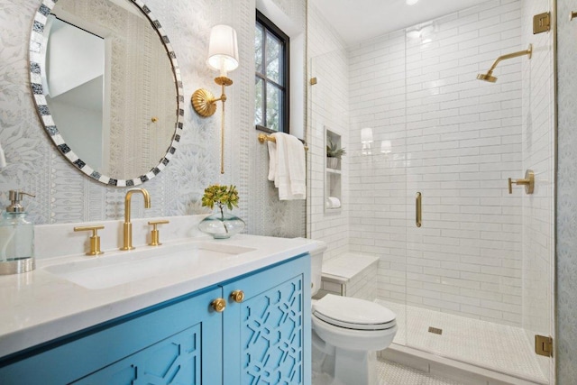 bathroom featuring tile patterned flooring, wallpapered walls, toilet, a stall shower, and vanity