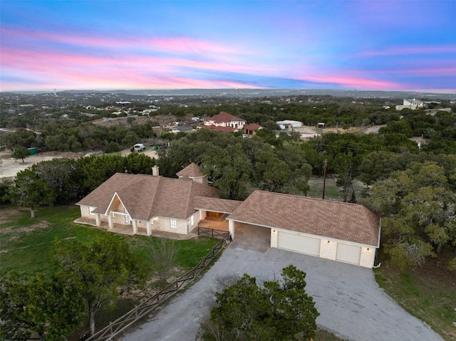 birds eye view of property featuring a view of trees