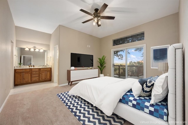 bedroom with ensuite bath, access to outside, light colored carpet, and baseboards