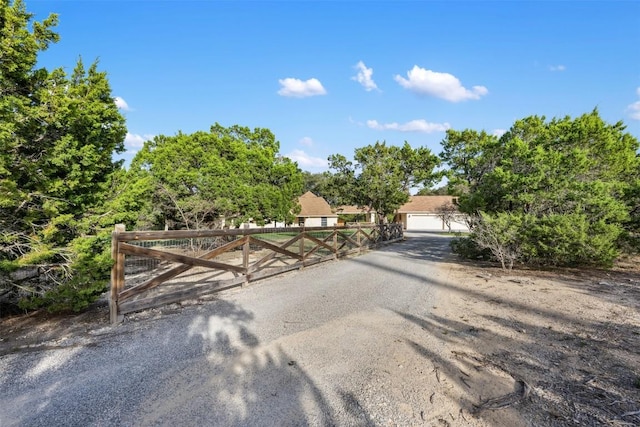 view of front of property featuring a garage and fence