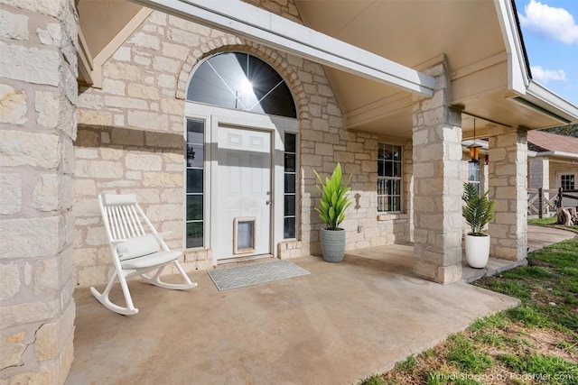 entrance to property featuring stone siding