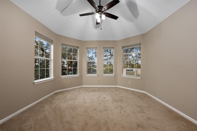 spare room with a wealth of natural light, cooling unit, baseboards, and carpet flooring