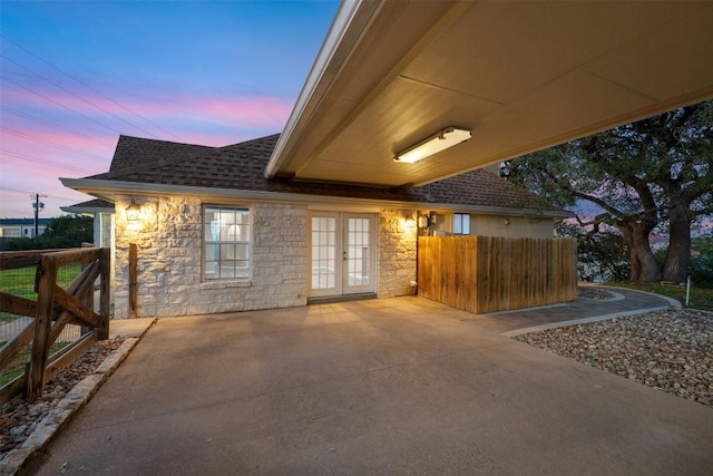 patio terrace at dusk with french doors and fence