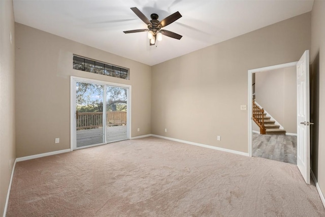 empty room featuring a ceiling fan, carpet, and baseboards