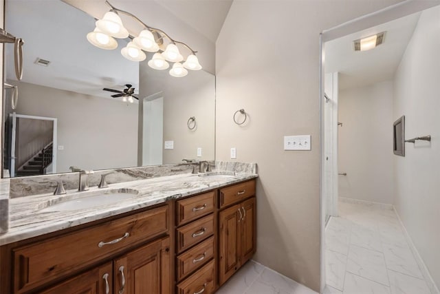 bathroom with a sink, marble finish floor, ceiling fan, and double vanity