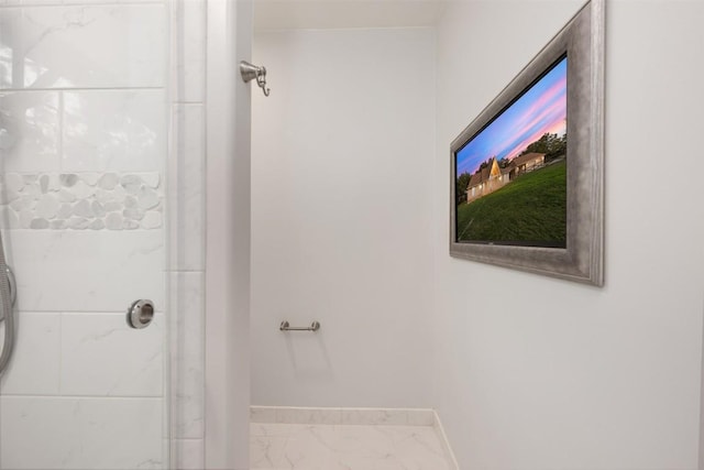 bathroom with a shower with shower door, baseboards, and marble finish floor