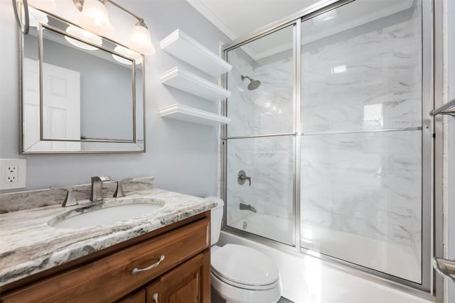 full bathroom featuring vanity, crown molding, toilet, and enclosed tub / shower combo