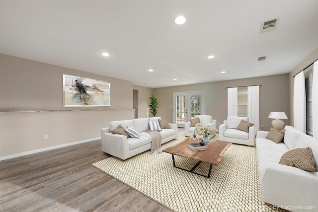 living area with recessed lighting, wood finished floors, visible vents, and french doors