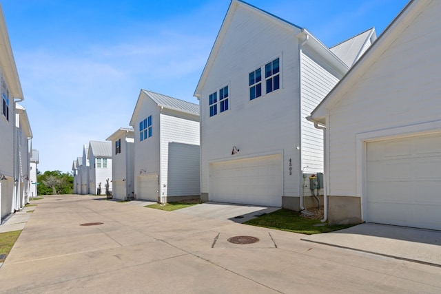 view of side of property with a garage and driveway