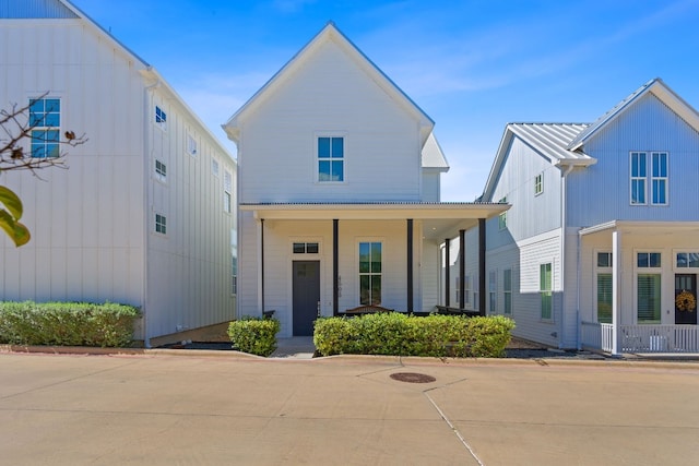 view of front of house with covered porch and metal roof