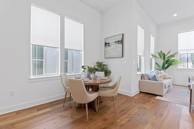 dining room with recessed lighting, baseboards, and hardwood / wood-style floors