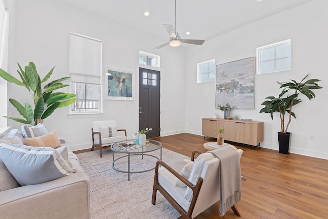 living room with recessed lighting, wood finished floors, and baseboards