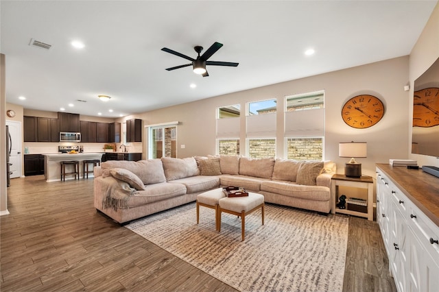 living room featuring visible vents, recessed lighting, and wood finished floors